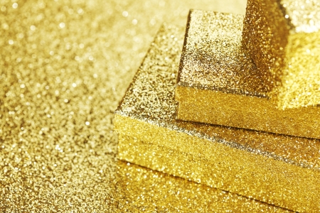 Golden boxes with holiday gifts on shiny glitter backgroundの写真素材
