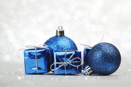 Blue Christmas gift boxes and balls on shiny silver backgroundの写真素材