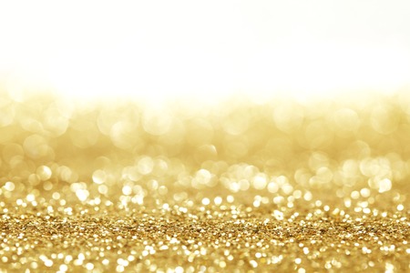 Golden shiny glitter holiday celebration background with white copy space Golden shiny glitter holiday celebration background with white copy space