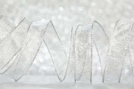 Curly silver Gift ribbon on shiny background close-upの写真素材