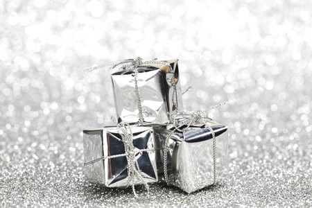 Boxes with christmas gifts on shiny silver background