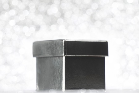 Silver holiday gift on glitter backgroundの写真素材