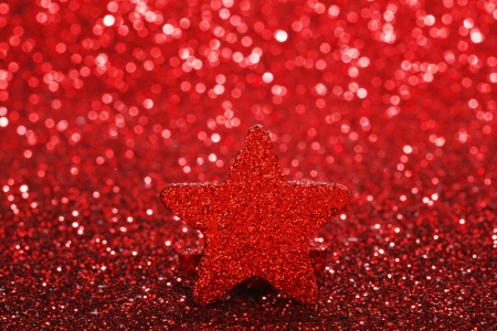 Christmas card with beautiful shiny decorative star over red backgroundの写真素材