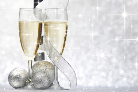 New year card with Champagne and decoration over shiny stars backgroundの写真素材