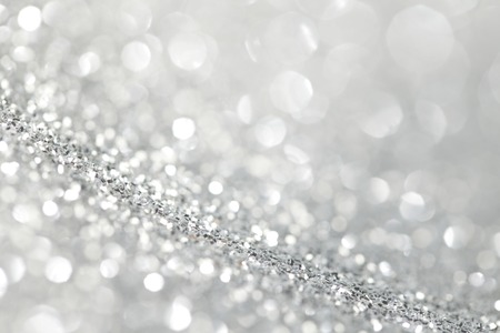 Silver festive glitter background with defocused lightsの写真素材