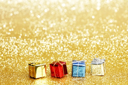 Small decorative colorful presents on glitter backgroundの写真素材
