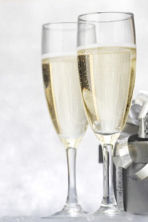 Champagne and present on silver bokeh backgroundの写真素材