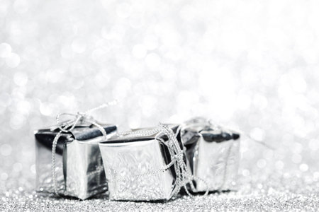 Decorated holiday gifts on silver backgroundの写真素材