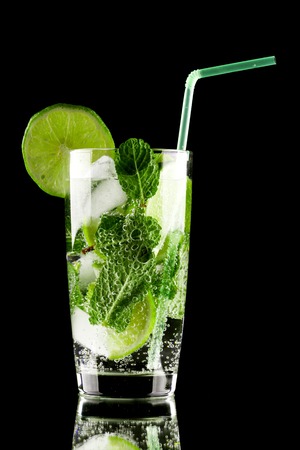 Mojito cocktail with lime, mint and ice on black backgroundの写真素材