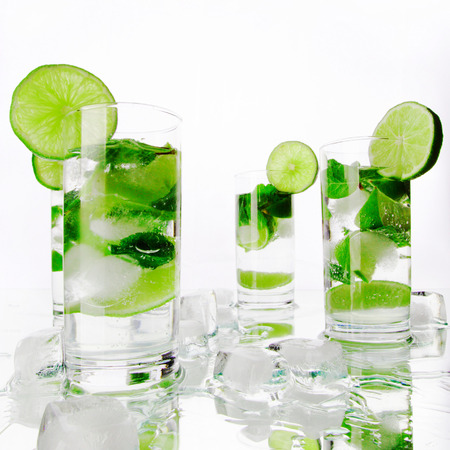 Party mojito cocktails with lime and mint isolated on white backgroundの写真素材