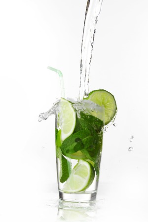 Making mojito cocktail with lime and mint isolated on white backgroundの写真素材