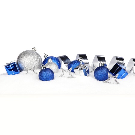 Christmas card with decorative baubles on snowの写真素材