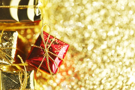 Decorative boxes with holiday gifts on abstract gold backgroundの写真素材
