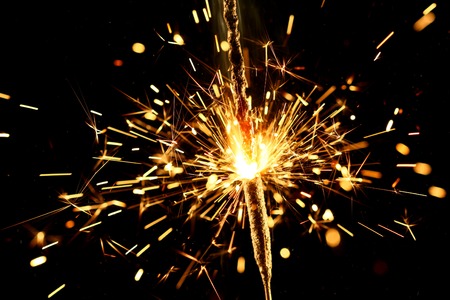Holiday sparkler close up isolated on black backgroundの写真素材