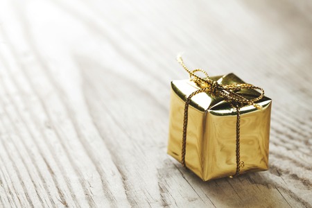 Small gift box on wooden background macro close-upの写真素材