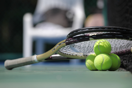 Tennis ball and racket on court close upの写真素材