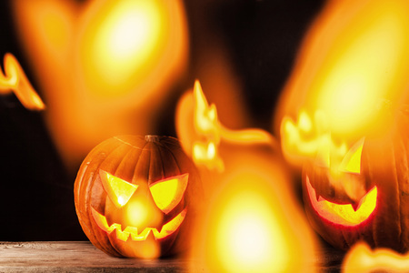 Funny glowing Halloween pumpkins on a black background