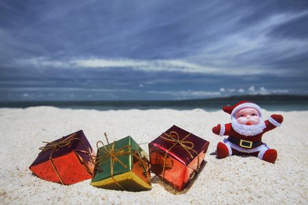 Christmas gifts on the sand of tropical sea beachの写真素材