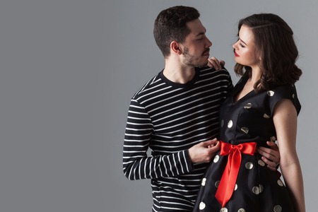 Beautiful young loving couple hugging and looking at each otherの写真素材