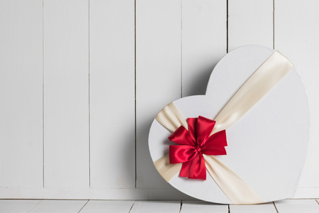 Heart shaped Valentines Day gift box on white wooden backgroundの写真素材
