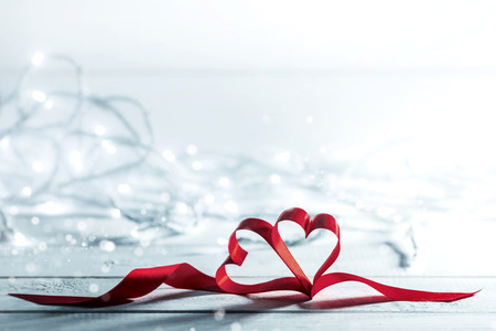 Two ribbon hearts on glowing bokeh lights backgroundの写真素材