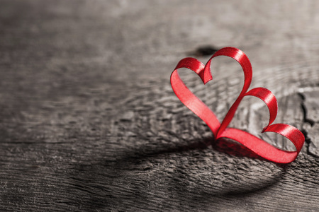 Two red ribbon hearts on wooden backround, Valentine day conceptの写真素材