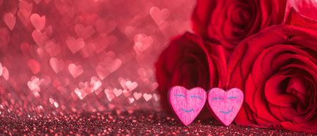 Roses and hearts on red glowing bokeh hearts background for Valentines dayの写真素材
