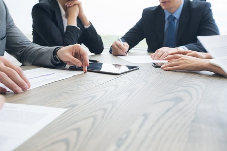 Business people work with documents and computers at office table close upの写真素材