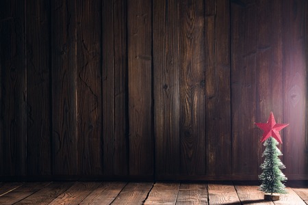 Small decorative Christmas tree on natural wooden backgroundの写真素材