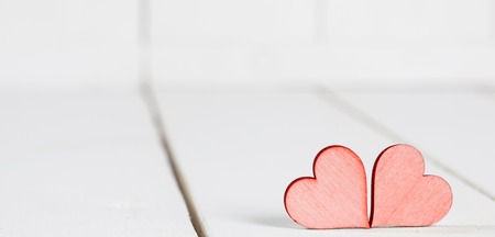 Two small hearts on old wood backgroundの写真素材