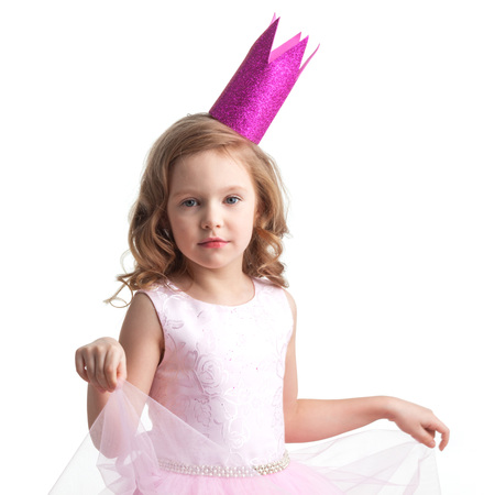 Happy small princess girl in pink dress and crown isolated on white backgroundの写真素材