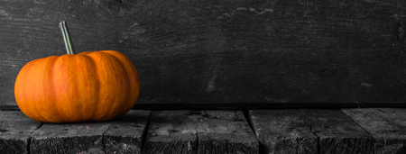 One orange pumpkin on dark wooden background, Halloween conceptの写真素材