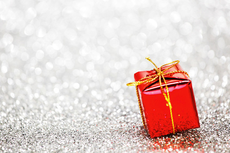 Decorated red holiday gifts on silver background