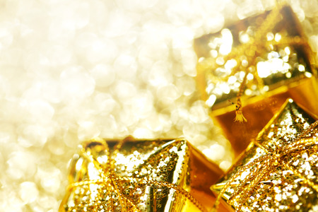 Gold decorative boxes with holiday gifts on abstract gold backgroundの写真素材