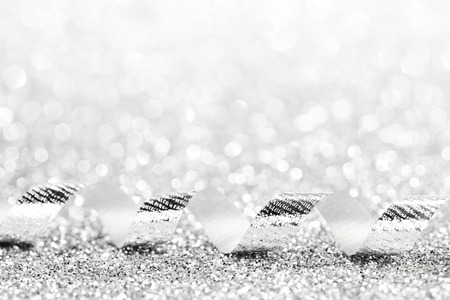 Curly decorative gift ribbon on shiny glitter backgroundの写真素材