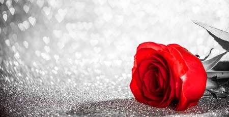Beautiful red rose on heart shape bokeh glitter backgroundの写真素材