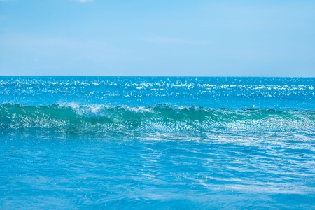 Blue tropical sea waves and clear sky backgroundの写真素材