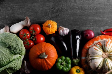Harvest of many vegetables on rustic wooden table background border frame with copy space for textの写真素材