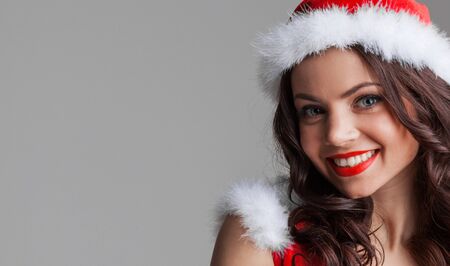 Beautiful happy woman in Santa Claus clothesの写真素材