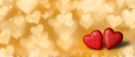 Two handmade wooden red hearts on golden glitter bokeh background. Vintage style. Love Valentine's Day concept.の写真素材