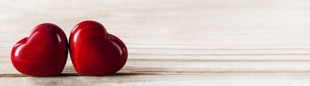 Two red wooden hearts symbol of love on wooden background, Saint Valentine Day celebration, copy space for textの写真素材