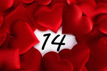 Valentine's day red silk hearts on calendar with 14 february date background, love, celebration conceptの写真素材