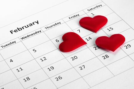 Valentine's day red silk hearts on calendar with 14 february date background, love, celebration conceptの写真素材