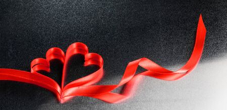 Two red ribbon hearts on metal background with copy space for text, Valentines day conceptの写真素材