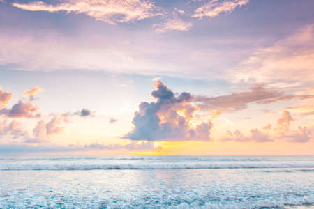 Morning seascape, beautiful sunrise in cloudy sky over the seaの写真素材