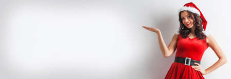 Christmas woman with open hand palm present poduct, white background with copy space for textの写真素材