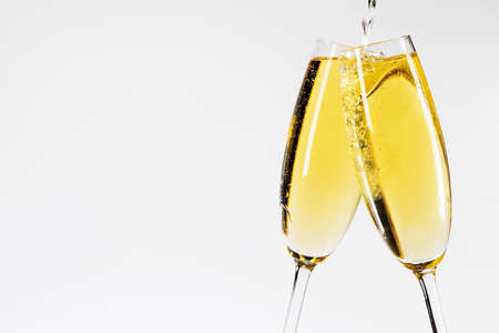 Champagne pouring in two glasses New Year celebrationの写真素材