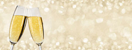 Two glasses of champagne with bokeh lights in the background New Year party celebration conceptの写真素材