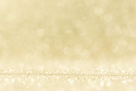 Shiny golden bokeh glitter lights abstract background, Christmas New Year party celebration conceptの写真素材
