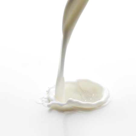 Pouring milk splash isolated on white background macroの写真素材
